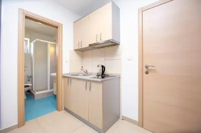 a small kitchen with a sink and a toilet at Apartments Vila Anastasia in Budva