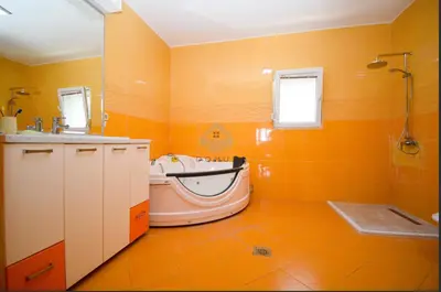 an orange bathroom with a tub and a sink at Baloci hills in Gornja Gorica