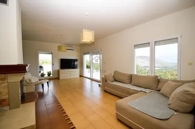 a living room with a couch and a television at Baloci hills in Gornja Gorica