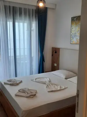 a bedroom with two beds and a window at Eagles Locus Apartments in Ulcinj