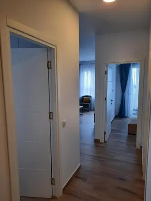 an empty hallway with an open door and a living room at Eagles Locus Apartments in Ulcinj
