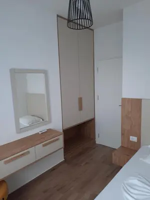 a bedroom with a mirror and a dresser at Eagles Locus Apartments in Ulcinj