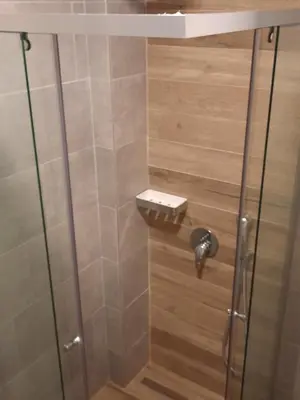 a shower with a glass door in a bathroom at Eagles Locus Apartments in Ulcinj