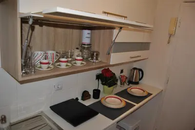 a small kitchen with a counter with dishes on it at Apartment Centar in Podgorica