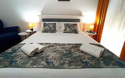 a bedroom with a bed with two towels on it at Apartment Centar in Podgorica