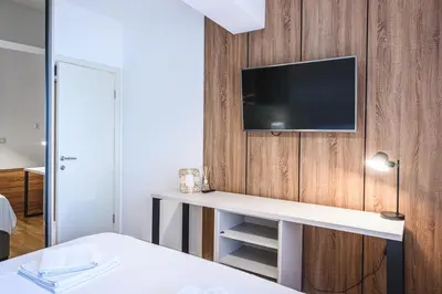 a room with a desk with a tv on a wall at Budva Harmonia in Boreti