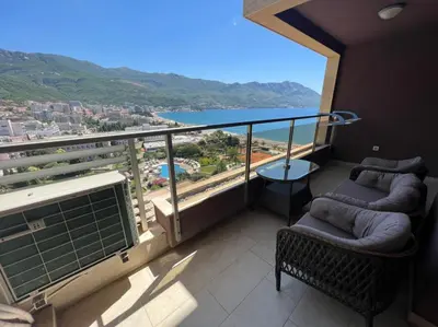 a balcony with two chairs and a view of the ocean at Budva Harmonia in Boreti