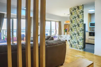 a living room with a brown couch and a table at Budva Harmonia in Boreti