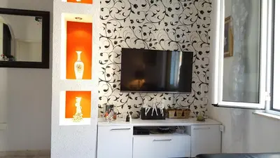 a living room with a tv on a wall at Apartment Kiki in Kotor