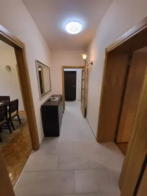 a hallway of a room with a door and a television at Centre Podgorica apartment in Podgorica