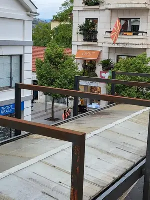 a wooden railing on a balcony of a building at Centre Podgorica apartment in Podgorica