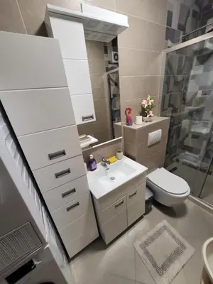 a bathroom with a sink and a toilet and a mirror at Centre Podgorica apartment in Podgorica