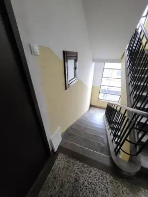 a hallway with a staircase in a building at Centre Podgorica apartment in Podgorica