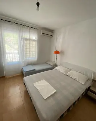 a bedroom with a large bed in a room at Apartmani Jovanovic Canj in Čanj