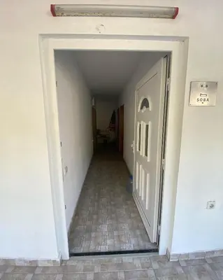 a hallway leading to a room with a door at Apartmani Jovanovic Canj in Čanj