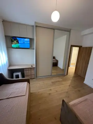 a living room with a large mirror and a couch at Fratelli Apartments in Tuzi
