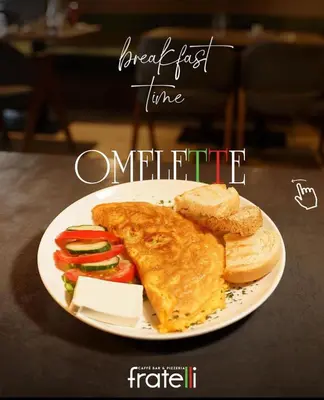 a plate of breakfast food with a sandwich and bread at Fratelli Apartments in Tuzi