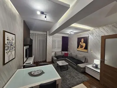 a living room with a couch and a table at AS Apartment in Podgorica