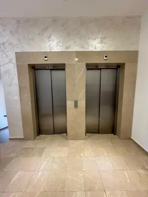 three elevator doors in a building with tile floors at Sunshine Master apartment in Podgorica