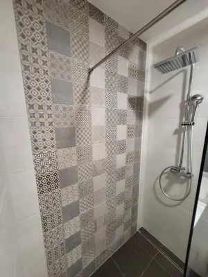 a bathroom with a shower with a glass door at Master apartment Podgorica in Podgorica