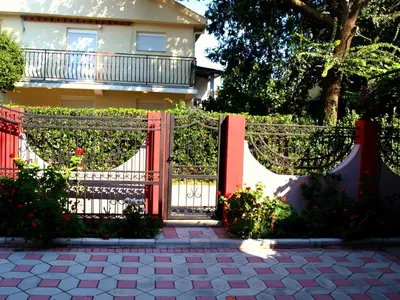 a red gate in front of a house at Friendly House in Ulcinj