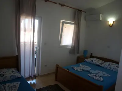 a bedroom with two beds and a window at Friendly House in Ulcinj