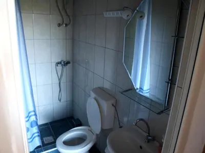 a bathroom with a toilet and a shower and a sink at Friendly House in Ulcinj
