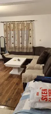 a living room with a couch and a table at Milan Apartman in Podgorica