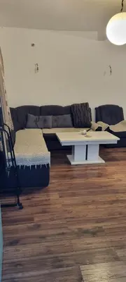 a living room with a couch and a table at Milan Apartman in Podgorica