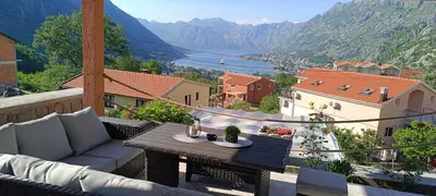 a balcony with a table and a view of a valley at Apartman Luka in Trojica