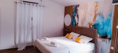 a bedroom with a bed with a mirror on the wall at Apartman Luka in Trojica