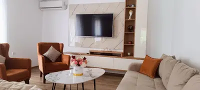 a living room with a couch and a tv at Apartman Lara 3 in Trojica