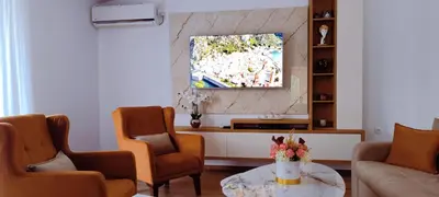 a living room with two chairs and a tv at Apartman Lara 3 in Trojica
