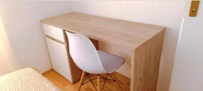 a desk with a white chair next to a desk at Apartman Lara 3 in Trojica