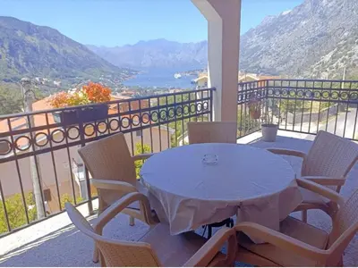 a table and chairs on a balcony with a view at Apartman Lara 3 in Trojica