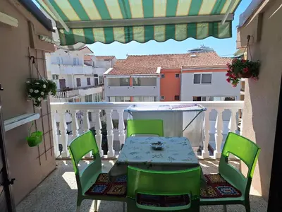 a patio with a table and chairs on a balcony at Adriatic Luxury Flat in Budva