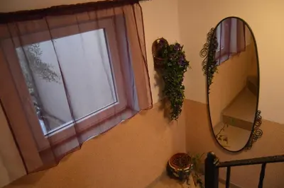 a mirror and a window in a room at Vila Maslina Guesthouse in Budva