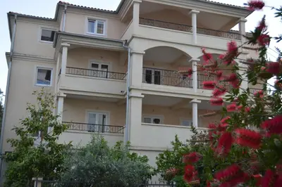 a building with balconies on the side of it at Vila Maslina Guesthouse in Budva