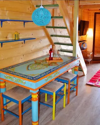 a table with four chairs in a room at Amazing &Magic houses- Ada Bojana in Gornji Štoj