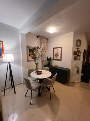 a living room with a table and chairs at Sea view in Rafailovici