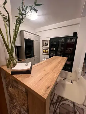 a kitchen with a wooden table and chairs at Sea view in Rafailovici