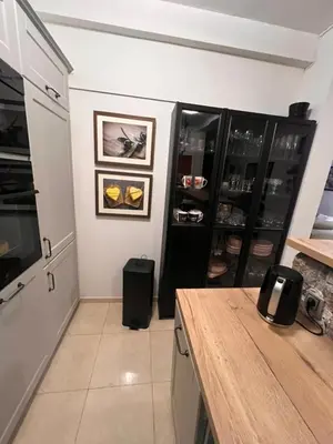 a kitchen with a refrigerator and a wooden counter top at Sea view in Rafailovici