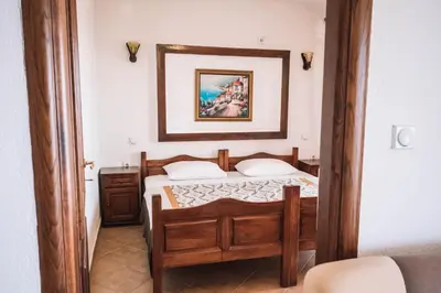 a bedroom with a bed and a picture on the wall at Bivalvia Apartments in Ulcinj