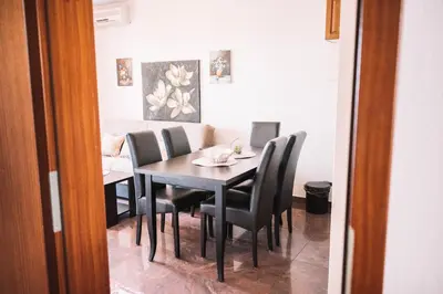 a dining room with a table and chairs at Bivalvia Apartments in Ulcinj