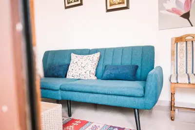 a blue couch sitting in a living room at Bivalvia Apartments in Ulcinj