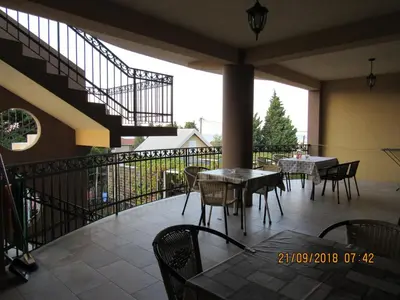 a balcony with tables and chairs and a staircase at Apartment Dasic in Bar