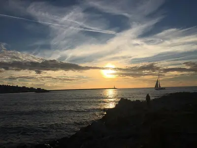a person standing on the beach watching the sunset at Apartment Dasic in Bar