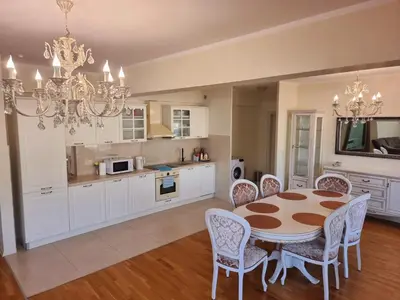 a kitchen with a dining room table and chairs at Harmonia Budva 1 in Budva