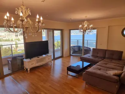 a living room with a couch and a flat screen tv at Harmonia Budva 1 in Budva