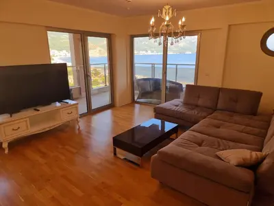 a living room with a couch and a flat screen tv at Harmonia Budva 1 in Budva